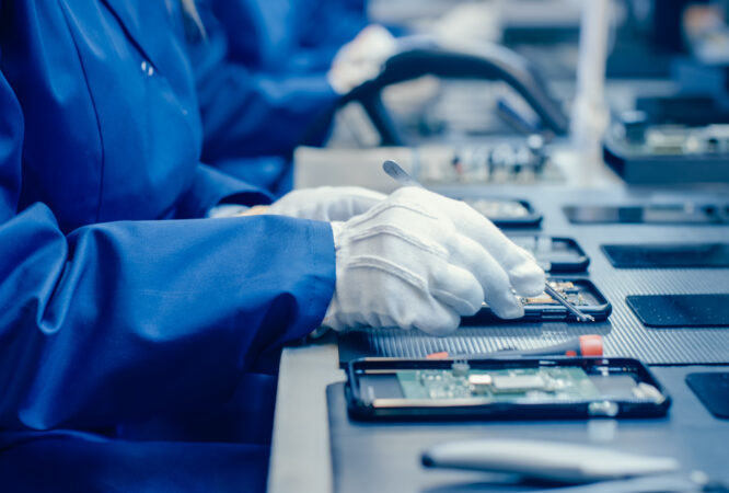 Close,Up,Of,A,Female,Electronics,Factory,Worker,In,Blue electronics industry Industrial