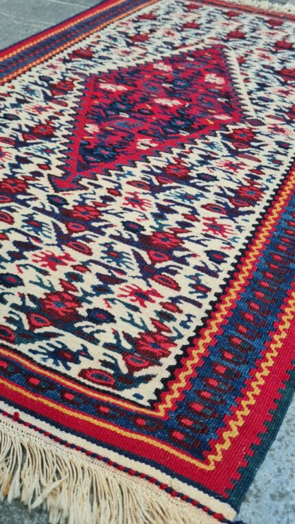 A vibrant,handwoven Sanandaj kilim with traditional Kurdish geometric patterns